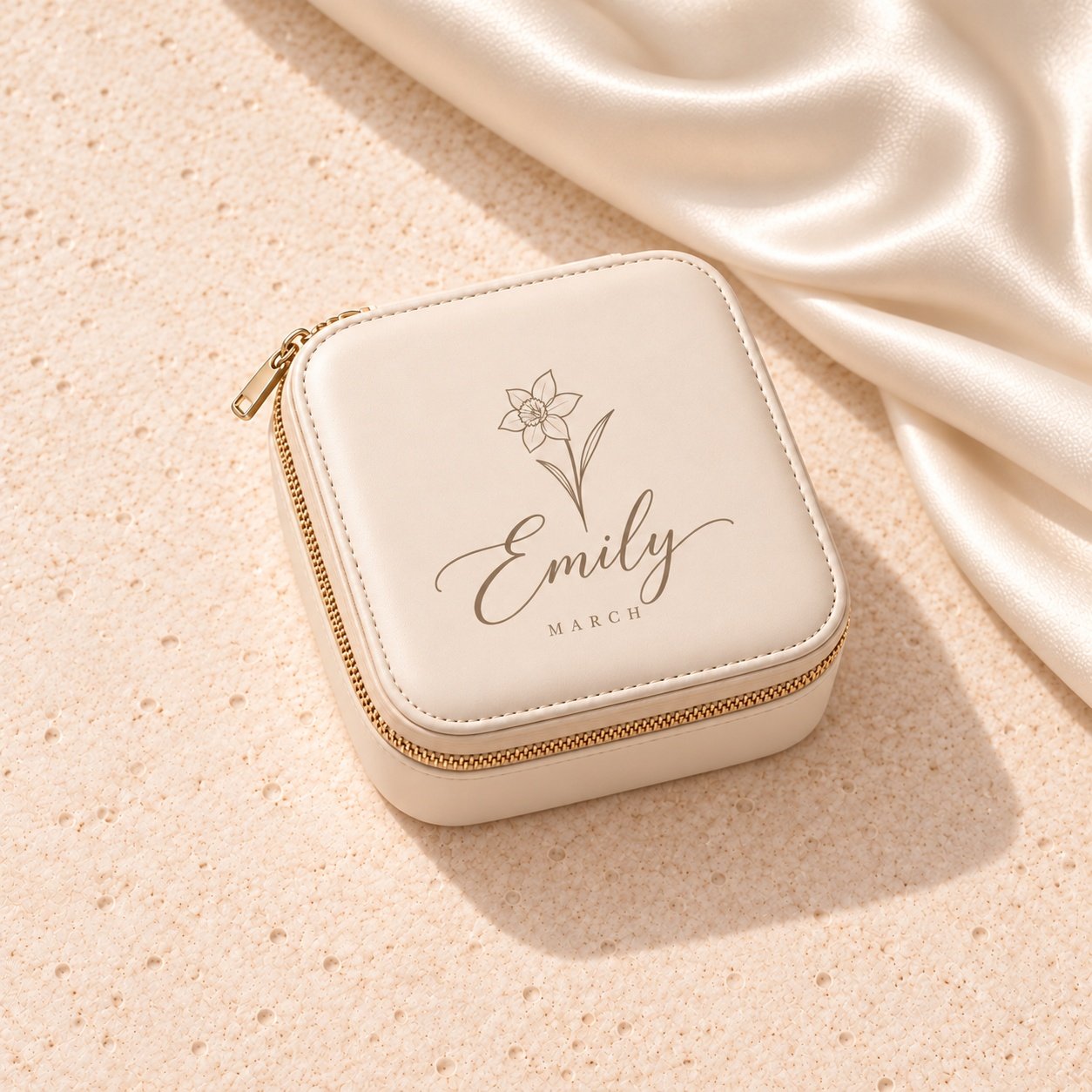 Ivory beige faux-leather jewelry travel case with taupe Emily lettering, a petite daffodil and March inscription